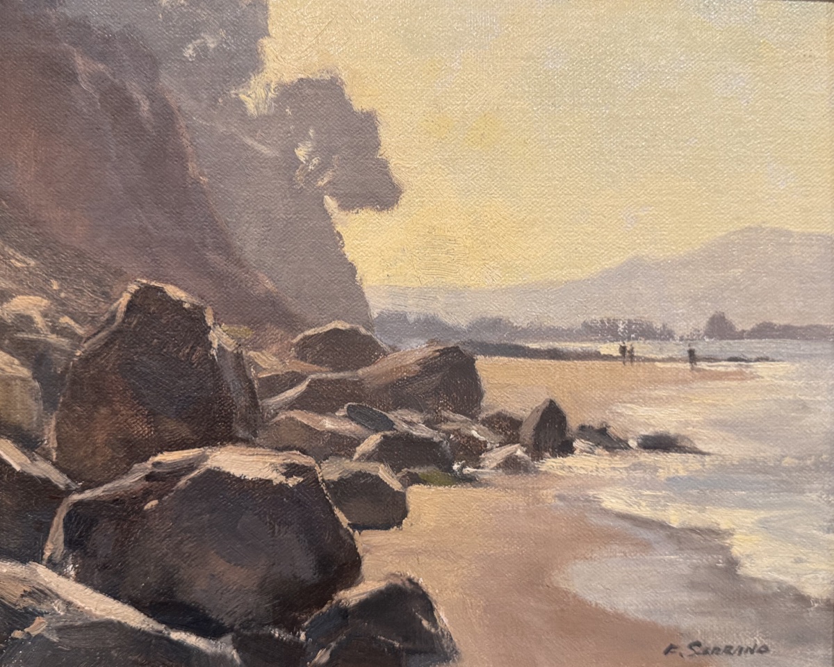 Boulders below the bluff at Loon Point, the beach and headland dissolving into coastal haze, three figures at the waterline.